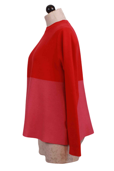side view of Pink and Red Colorblock Flared Sweater by Compania Fantastica