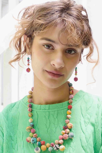 Model wearing the Multicolored Dripping Kantha Earrings by World Finds with a matching necklace