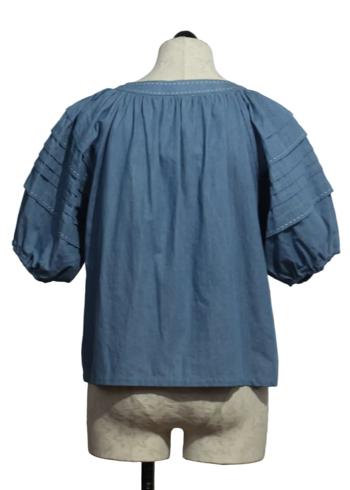 back view of Chambray Shay Contrast Stitch Peasant Top by Fifteen Twenty