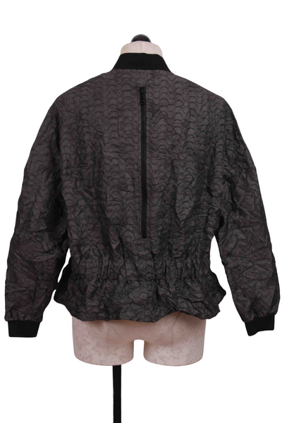 back view of Curve patterned zip front Amal Jacket by Kozan