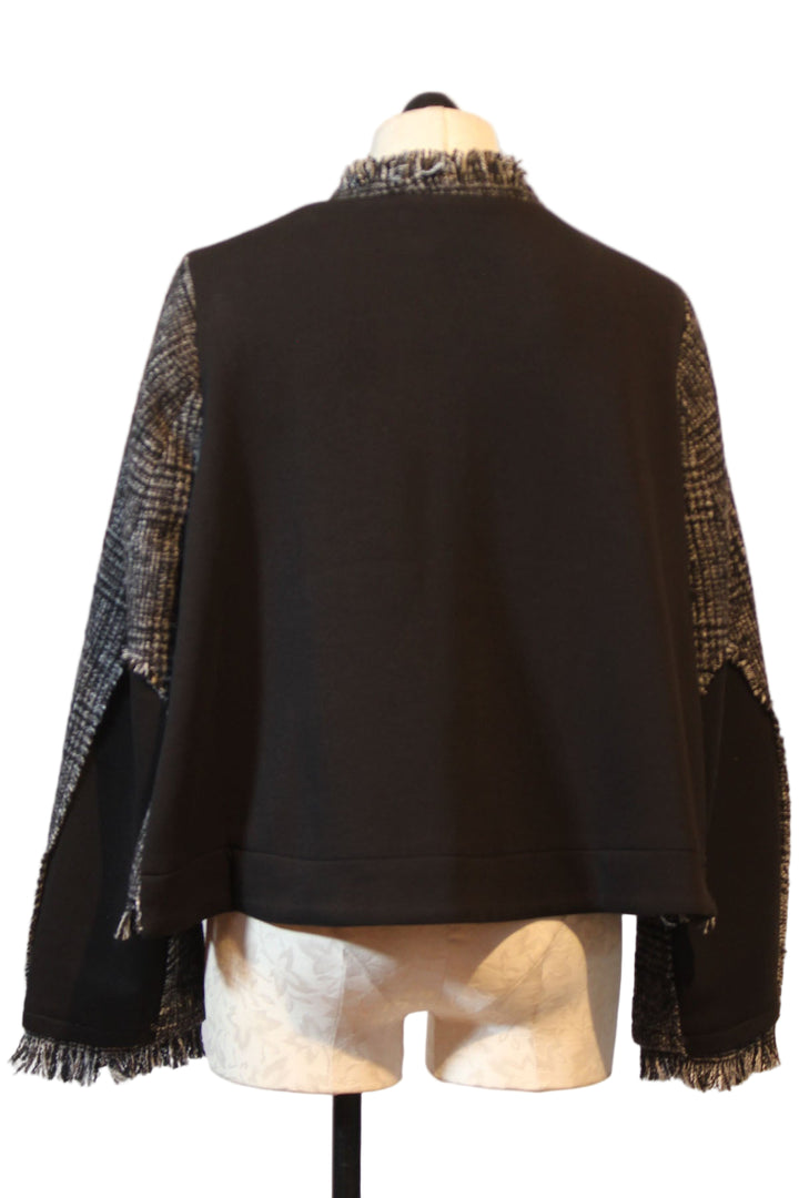 back view of Black and White Tweed Jacket by Moyuru with fringed edging and solid Black Back