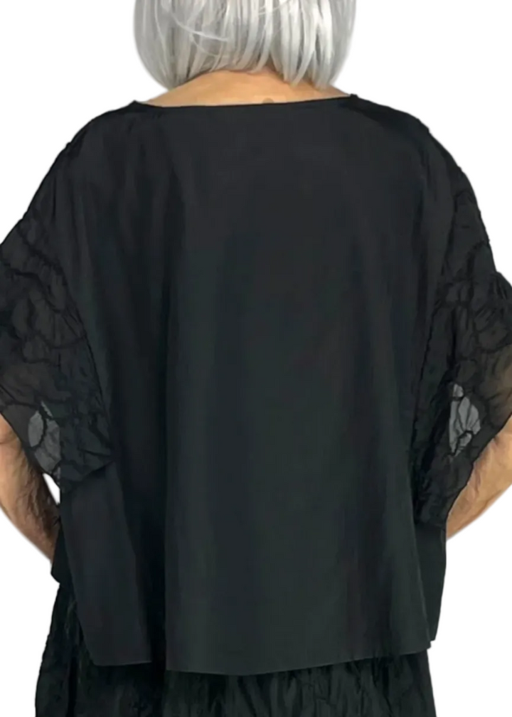 back view of The Embroidered Cap Sleeve Cropped Top by Moyuru 