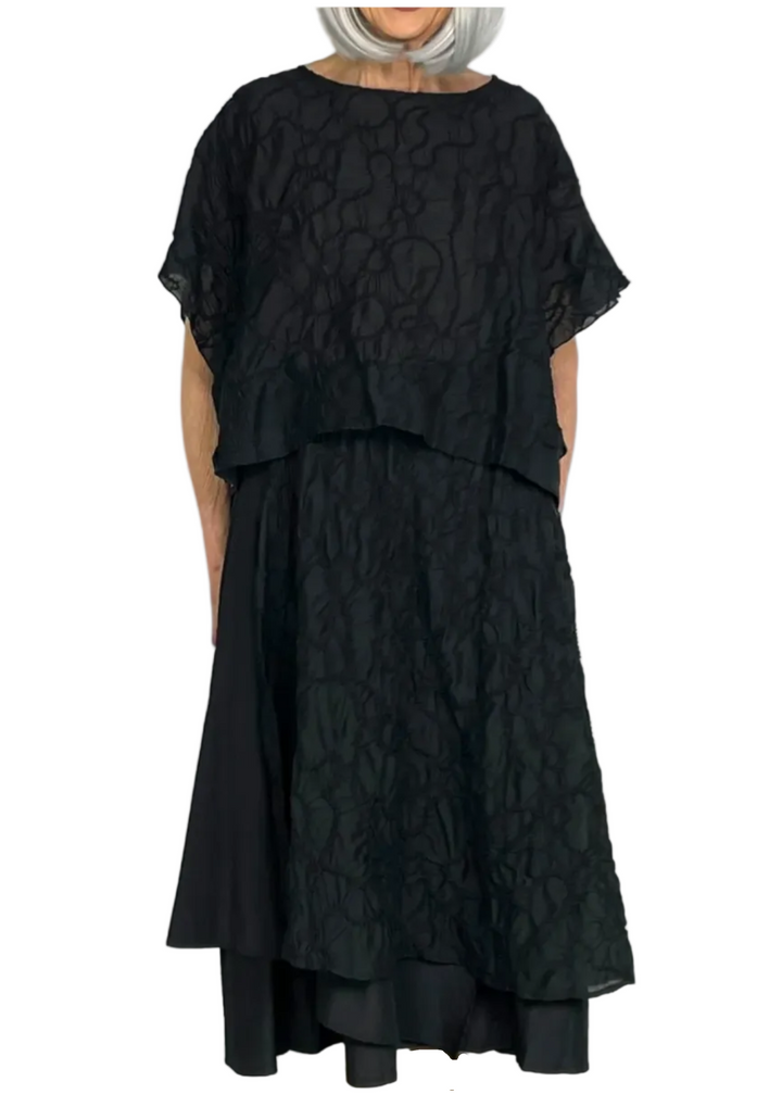 Model wearing the Black Embroidered Overlay Skirt by Moyuru paired with the matching black embroidered top by Moyuru