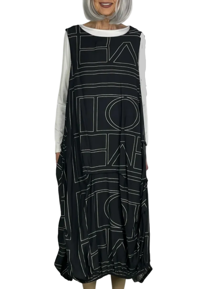 model wearing the Black Sleeveless Geometric Dress by Moyuru with a white tee underneath