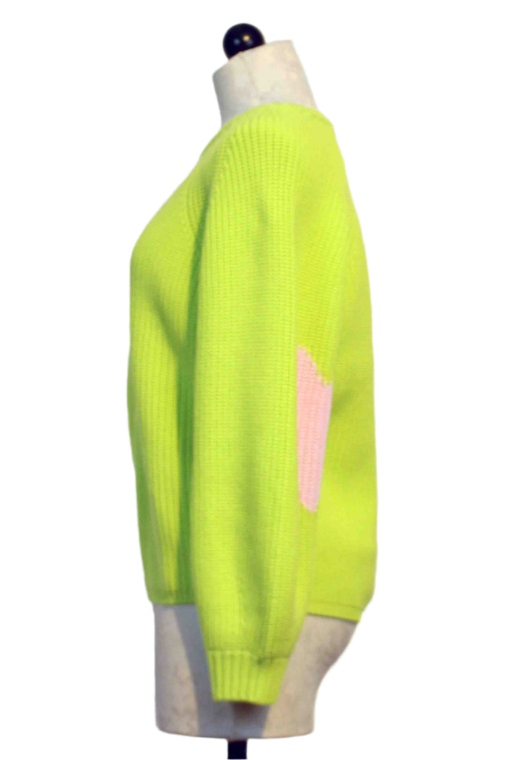 side view of Lime Green Ricki Imperfect Heart Sweater by Kerri Rosenthal with big Pink Hearts on each Elbow