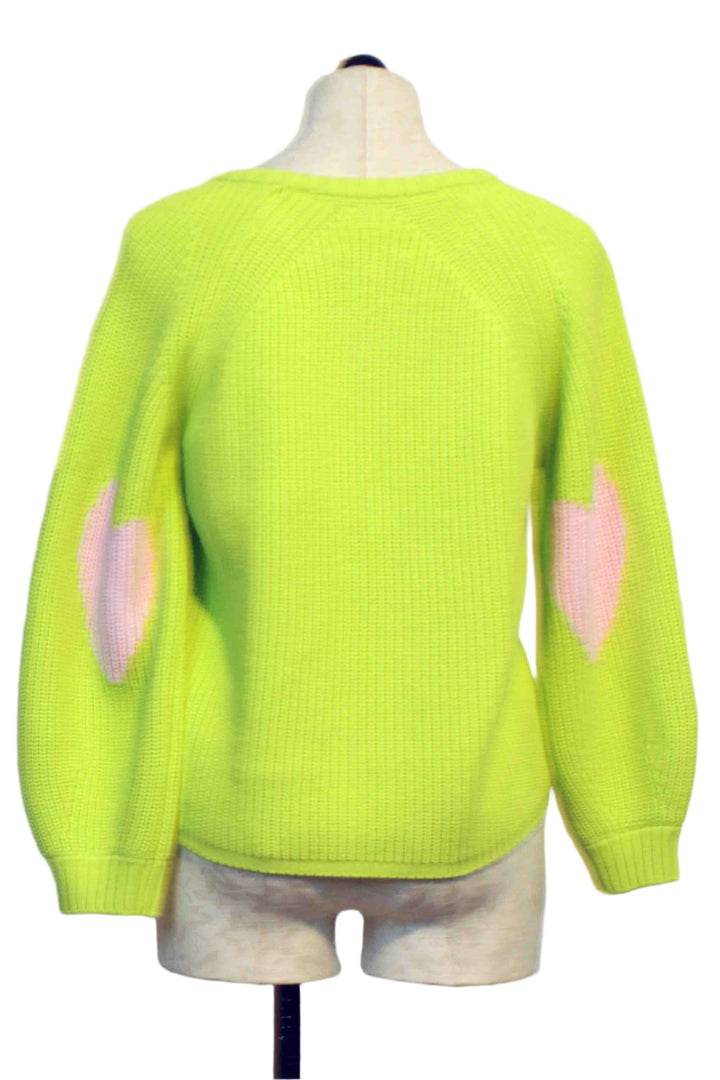 back view of Lime Green Ricki Imperfect Heart Sweater by Kerri Rosenthal with big Pink Hearts on each Elbow
