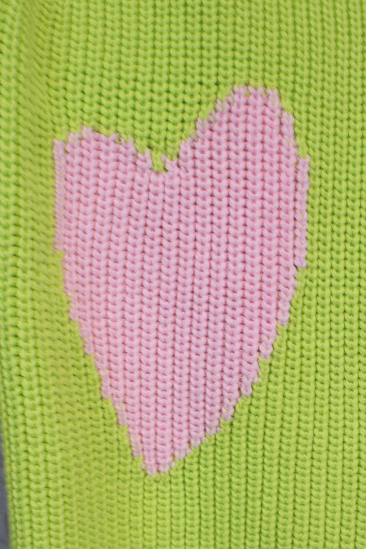 close up of the heart on Lime Green Ricki Imperfect Heart Sweater by Kerri Rosenthal on each elbow sleeve