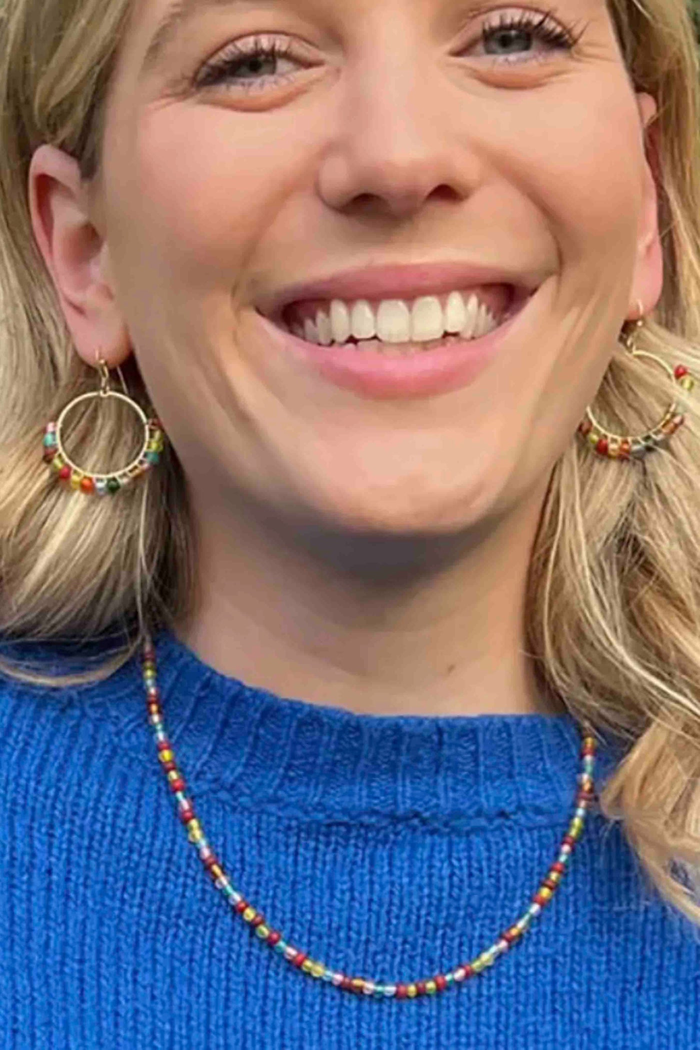 model wearing the multicolored Kaleidoscope Necklace by World Finds with a pair of matching earrings