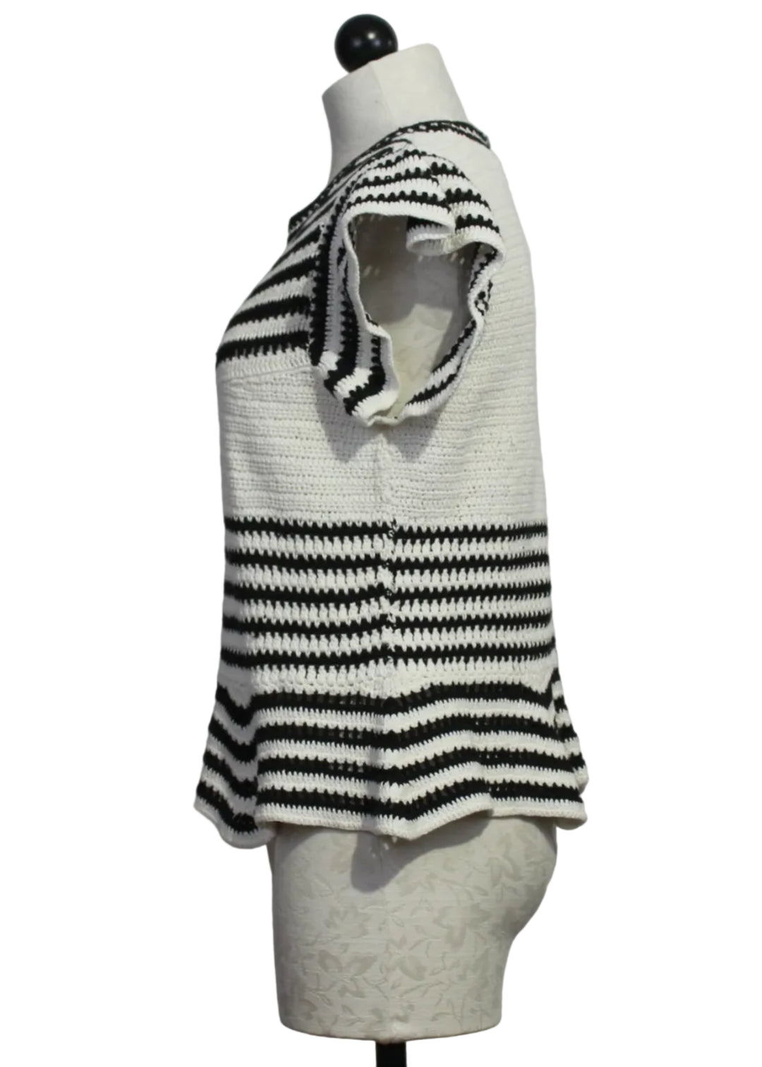 side view of The knit Regatta Knit Black and White Striped Audrey Top by Marie Oliver with ruffled shoulders and a peplum bottom