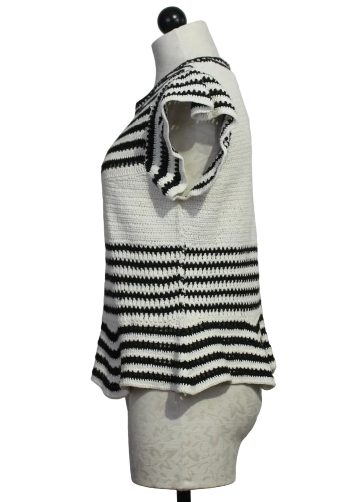 side view of The knit Regatta Knit Black and White Striped Audrey Top by Marie Oliver with ruffled shoulders and a peplum bottom