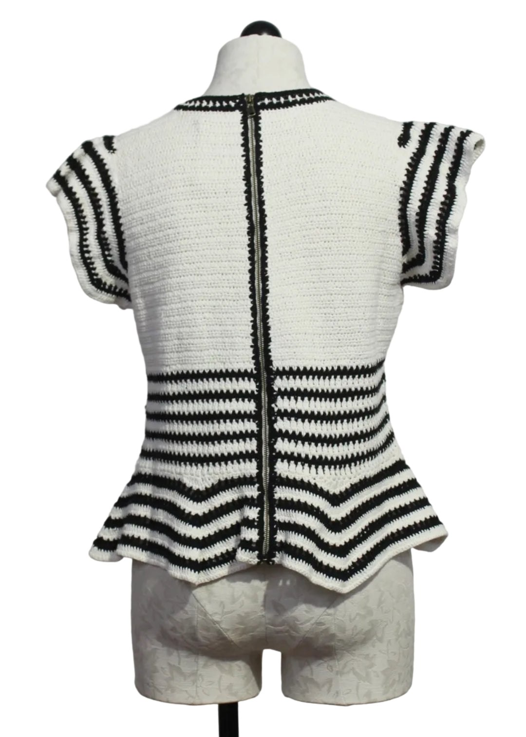 back view of The knit Regatta Knit Black and White Striped Audrey Top by Marie Oliver with ruffled shoulders and a peplum bottom