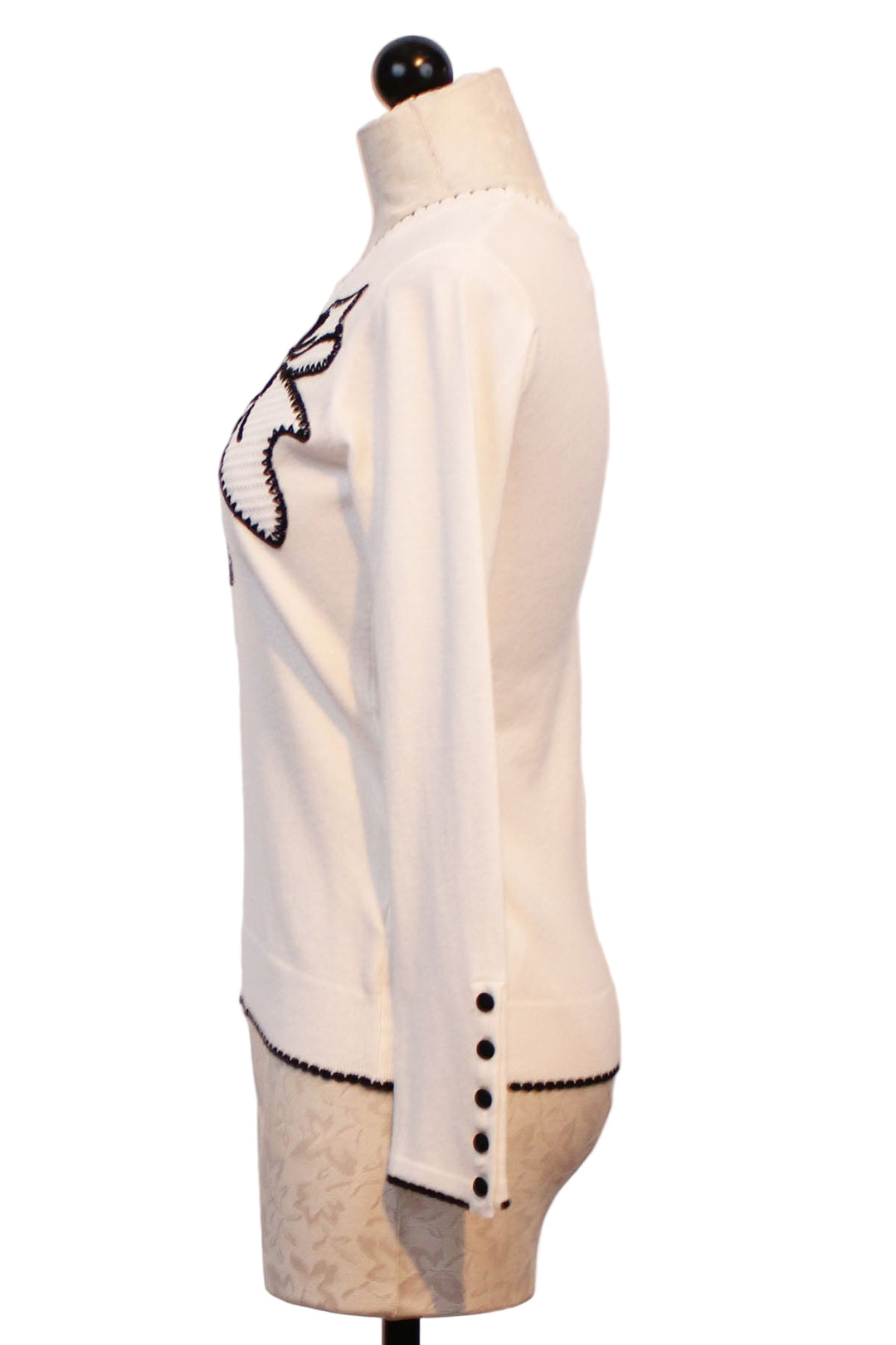 side view of Off White Sweater with Black outlined Embroidered Bow and whipstitched edges by Leo &amp; Ugo