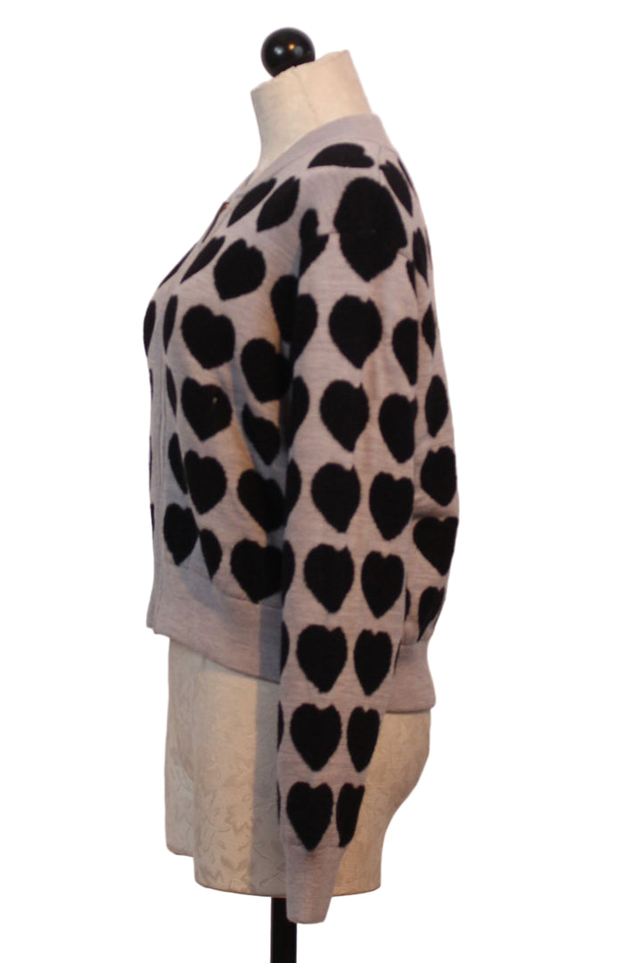 side view of Silver All Heart Zip Front Sweater by Lisa Todd with Black Hearts