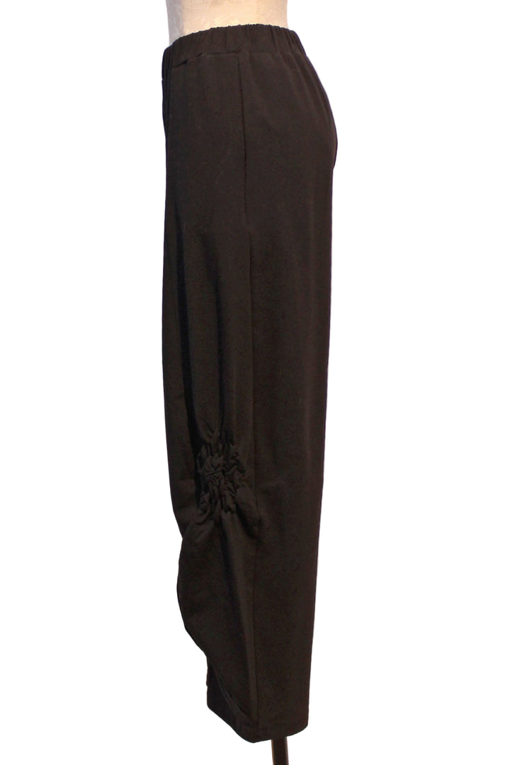 side view of Almila Pant by Kozan with ruched rosette-like detail along the bottom