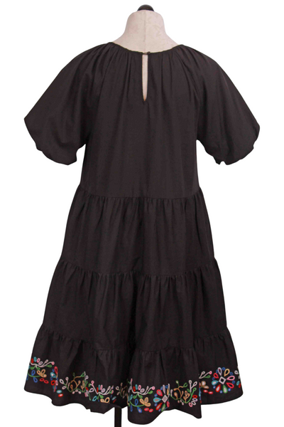 back view of Black Amanza Tiered Dress by Johnny Was with embroidered hem