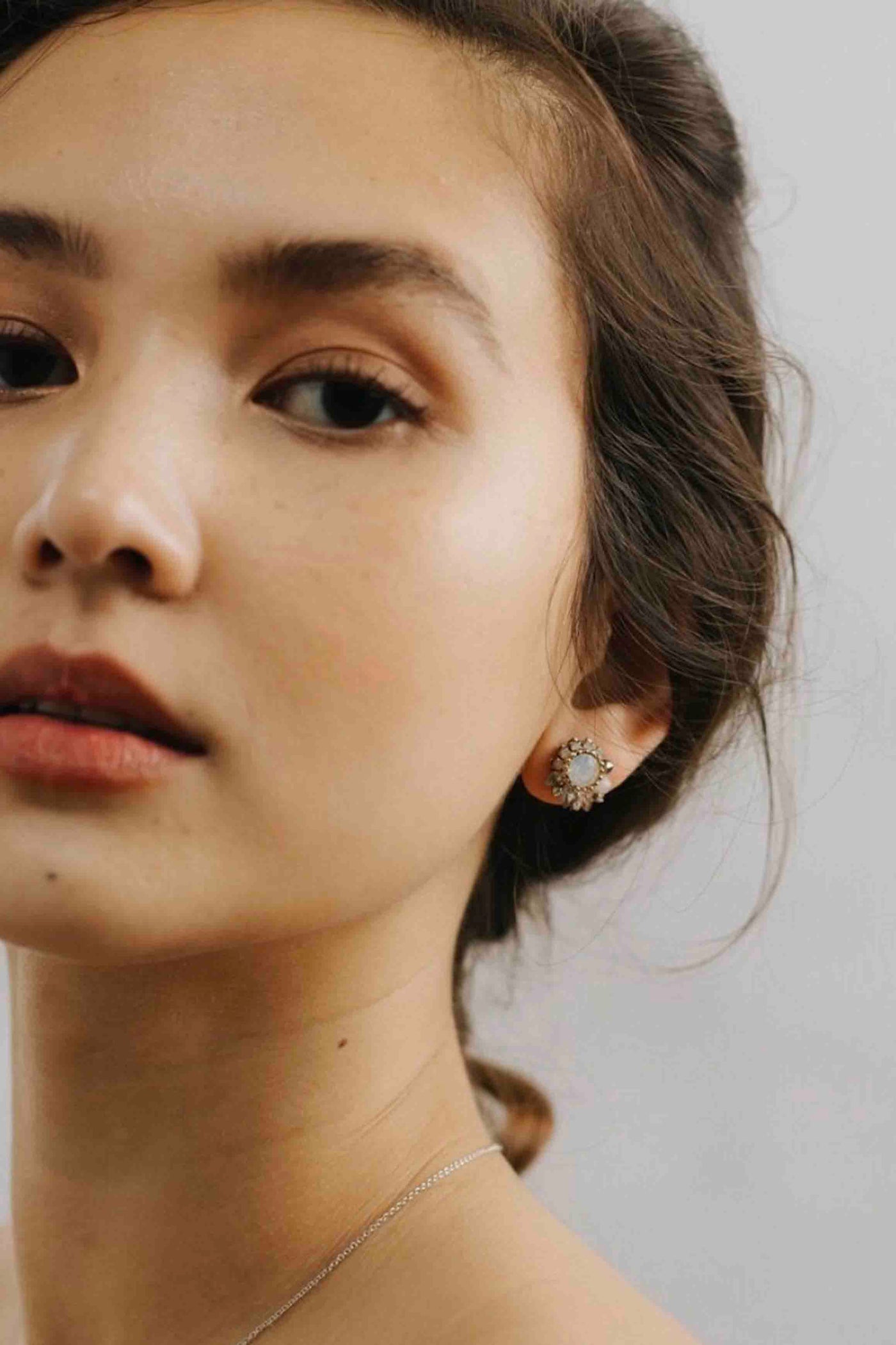 model wearing Amelia White Opal Crystal Post Earrings by Lover's Tempo