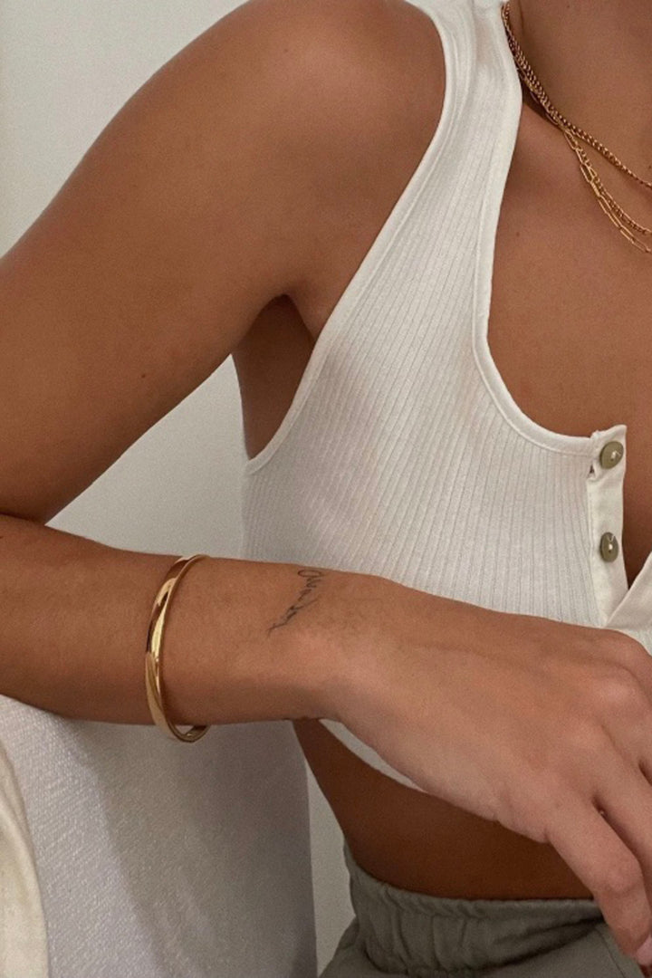 model wearing the Gold Plated Stainless Steel Arielle Bangle Bracelet by Ellie Vail with a Hinge Closure