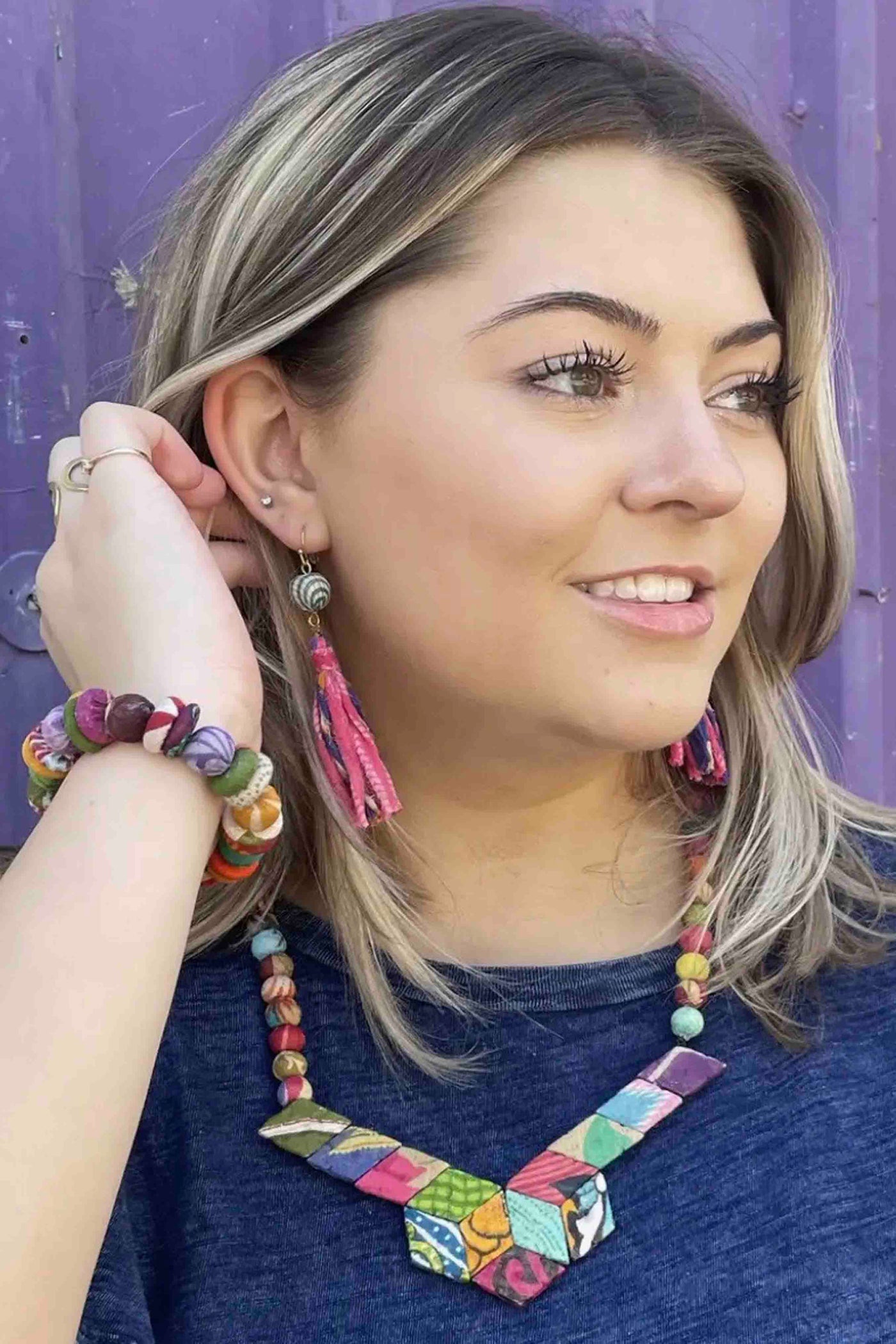 model wearing the multicolored Kantha Button Bracelet by World Finds with matching earrings and necklace