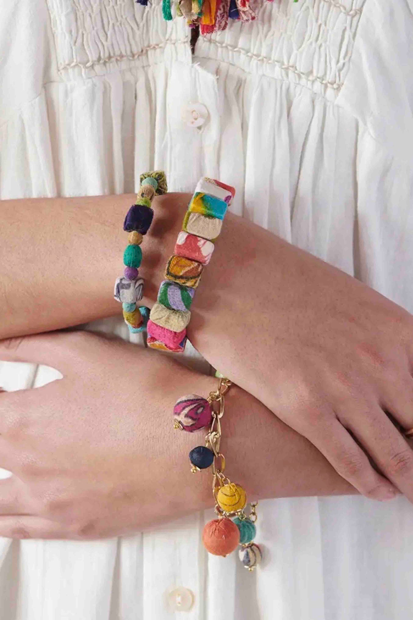 model wearing the Multicolored Kantha Block Bracelet by World Finds with 2 other World Finds Bracelets