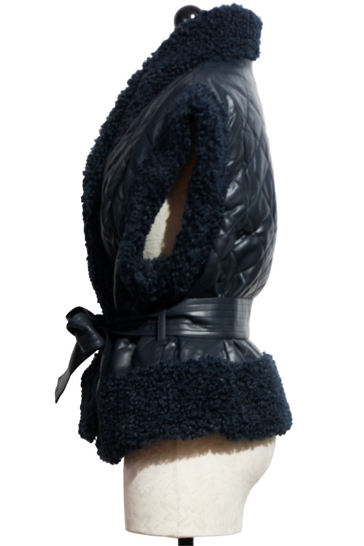 side view of Naval colored Beatrice Vest by Marie Oliver is a quilted vegan leather