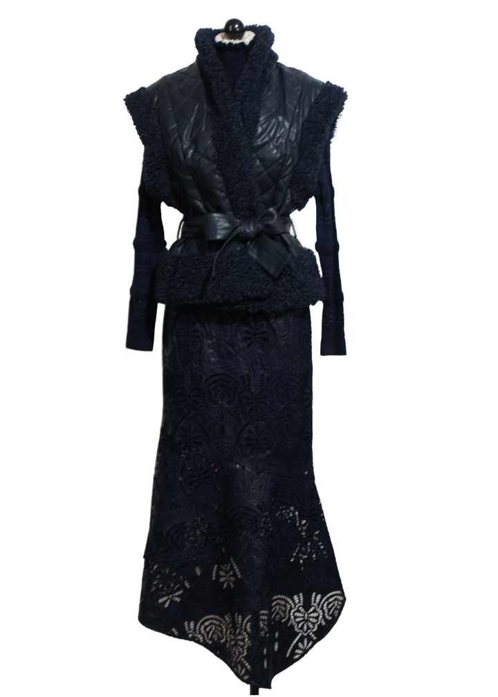Naval colored Beatrice Vest by Marie Oliver is a quilted vegan leather paired with the Pacific color Adison Top and Naval color Casey Skirt by Marie Oliver