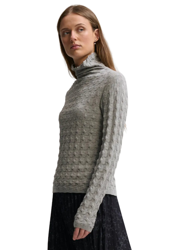 front/side view of model wearing the Cloud colored 3D TNECK by Margaret O&