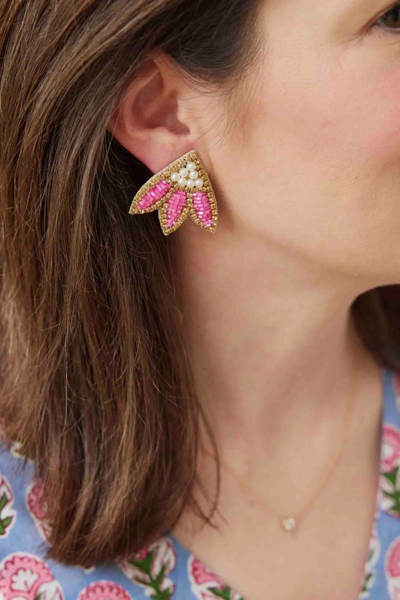 a model wearing the Pink Calypso Stud Earrings by Beth Ladd Collections