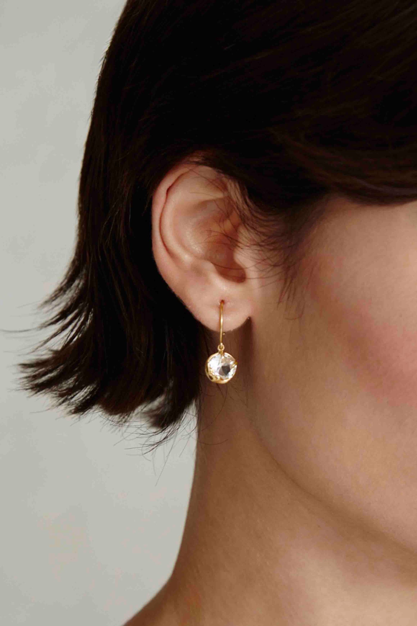 Model wearing the April Diamond Faceted Crystal Birthstone Earrings by Chan Luu