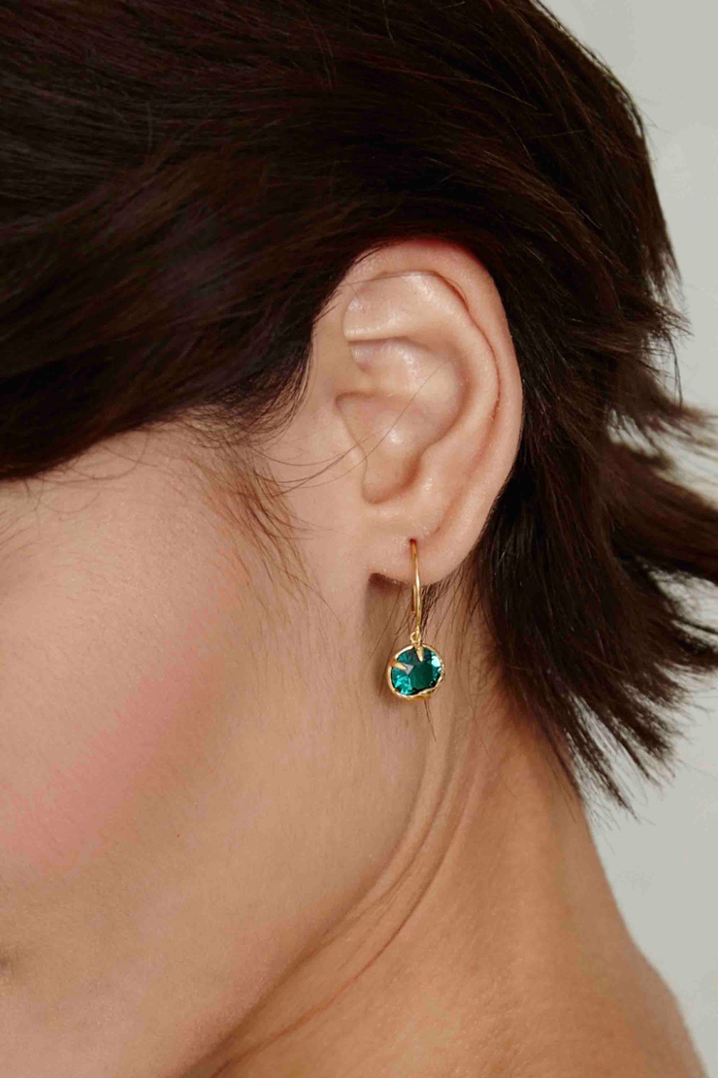 Model wearing the May Emerald Faceted Crystal Birthstone Earrings Chan Luu