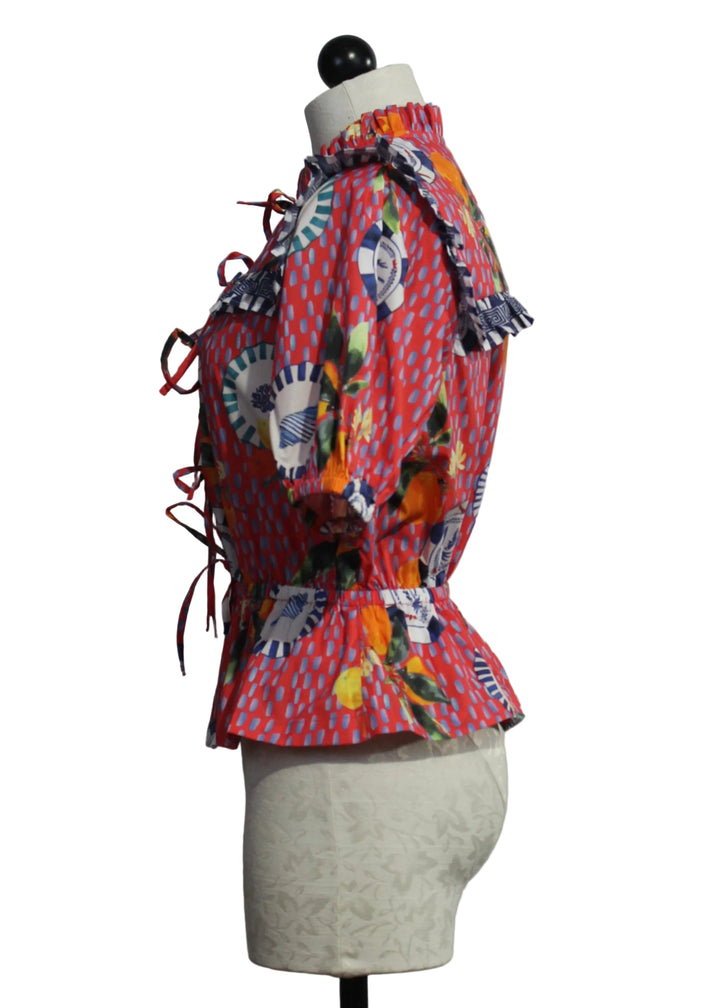 side view of The Freya Blouse by Emily Lovelock in the Lava Red Print