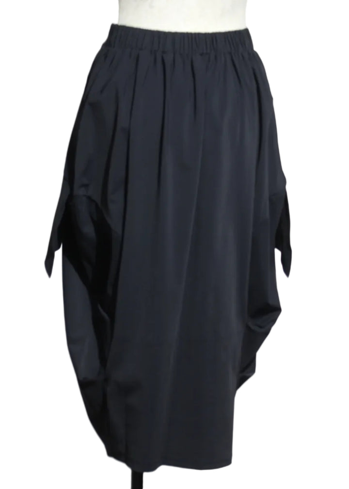 back view of Coal black The Vona Skirt by Kozan with apron-like side detail