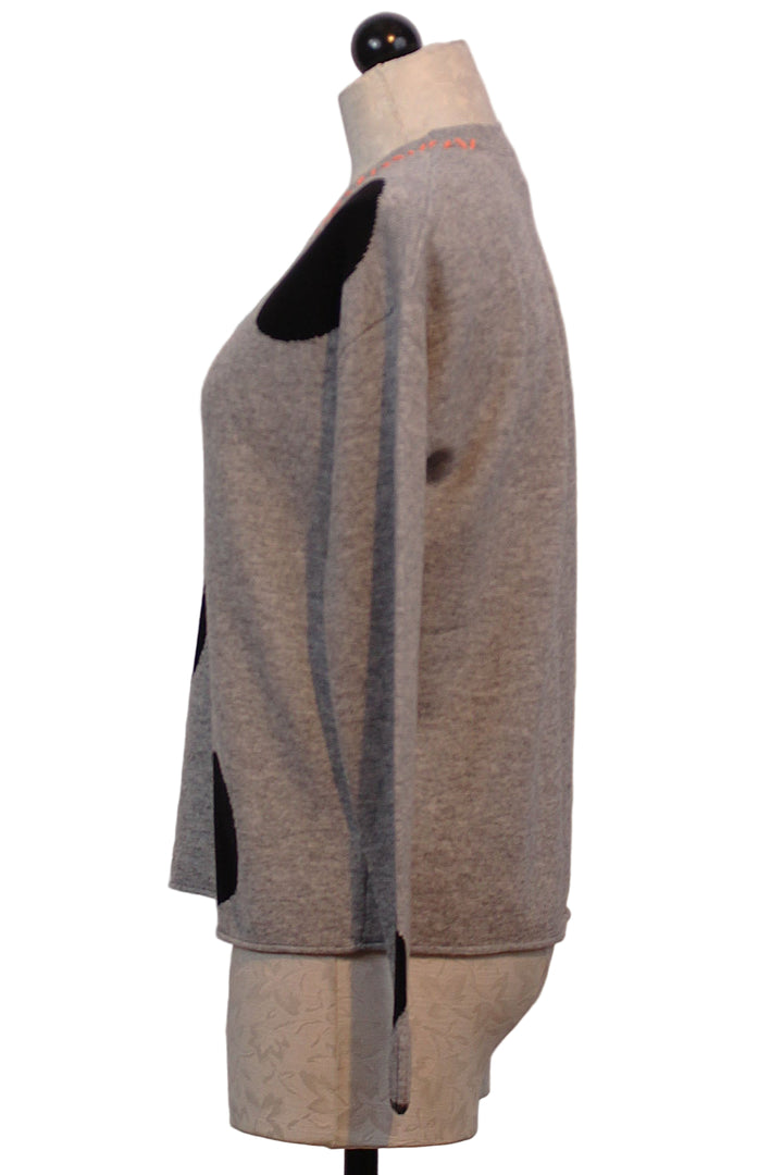 side view of Grey with black Dots Hot for Dots Sweater by Lisa Todd with Coral whipstitching