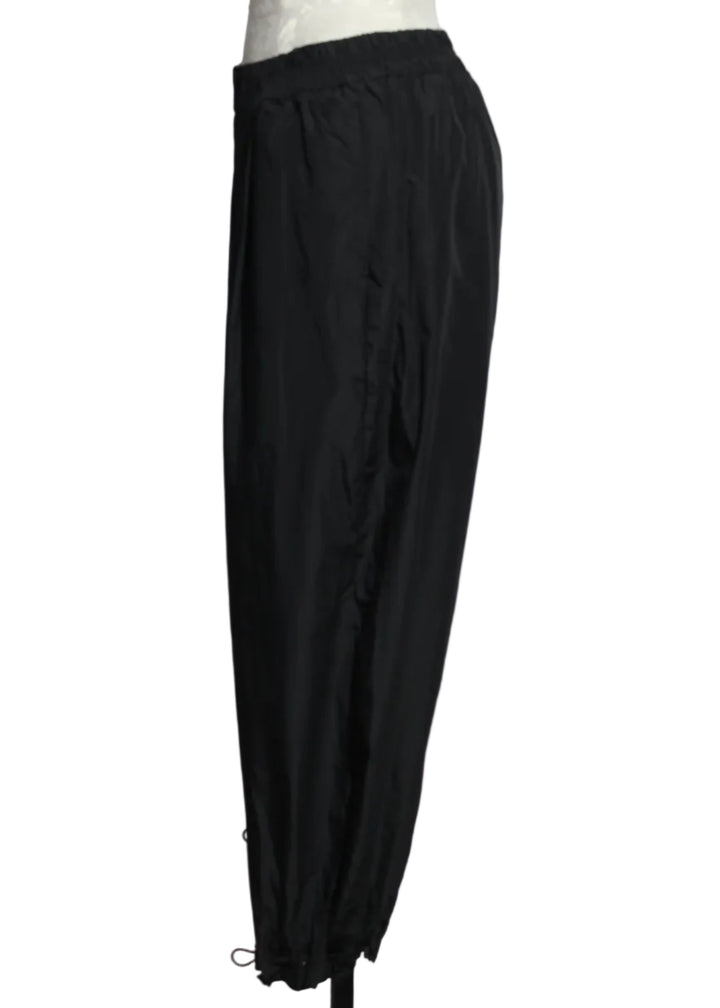 side view of Black The Andi Pant by Kozan is a wide leg cropped pant with drawstring cord hem