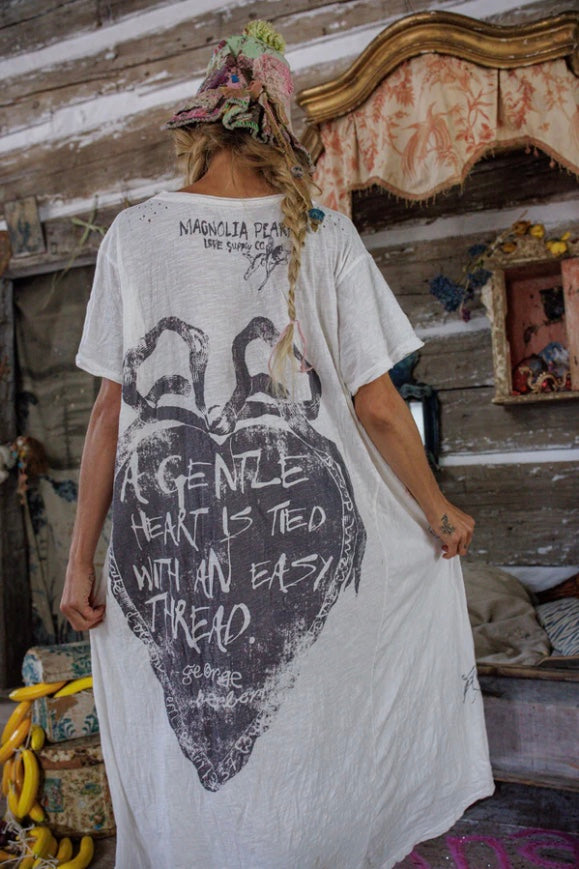 Back view of Ribbon Graphic on Back with Quote, "A gentle heart is tied with an easy thread. - George Herbert"
Magnolia Pearl Love Supply Co. Cupid Logo on Short Sleeve Cotton Jersey Let Love in T Dress by Magnolia Pearl in color True