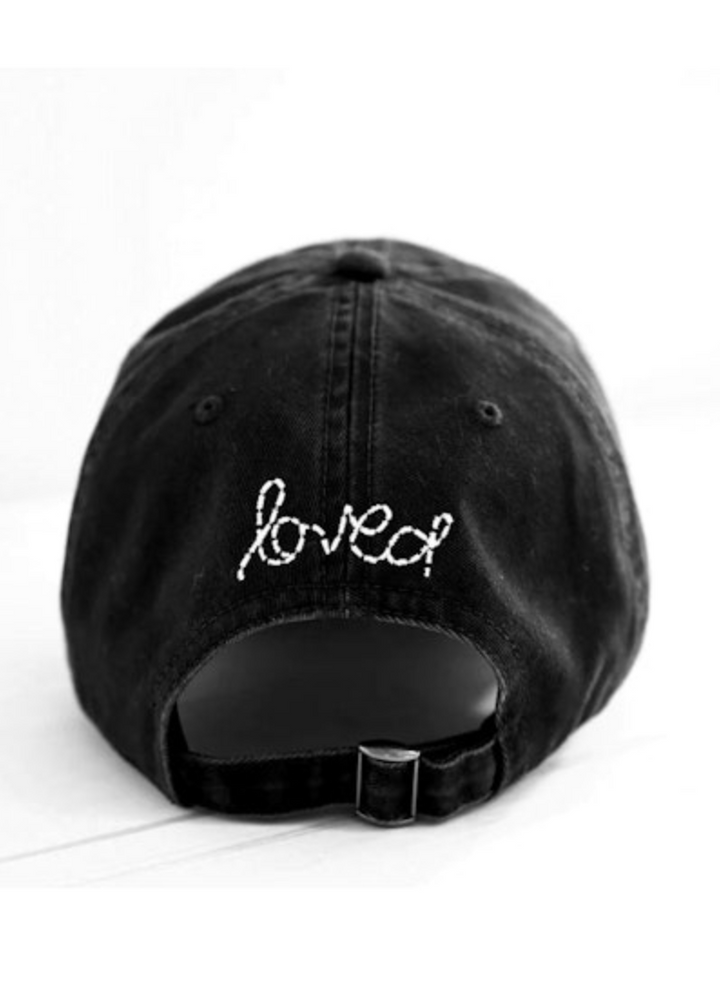 Black Baseball Hat with White Heart Patch by Kerri Rosenthal and "loved" whipstitched on the back
