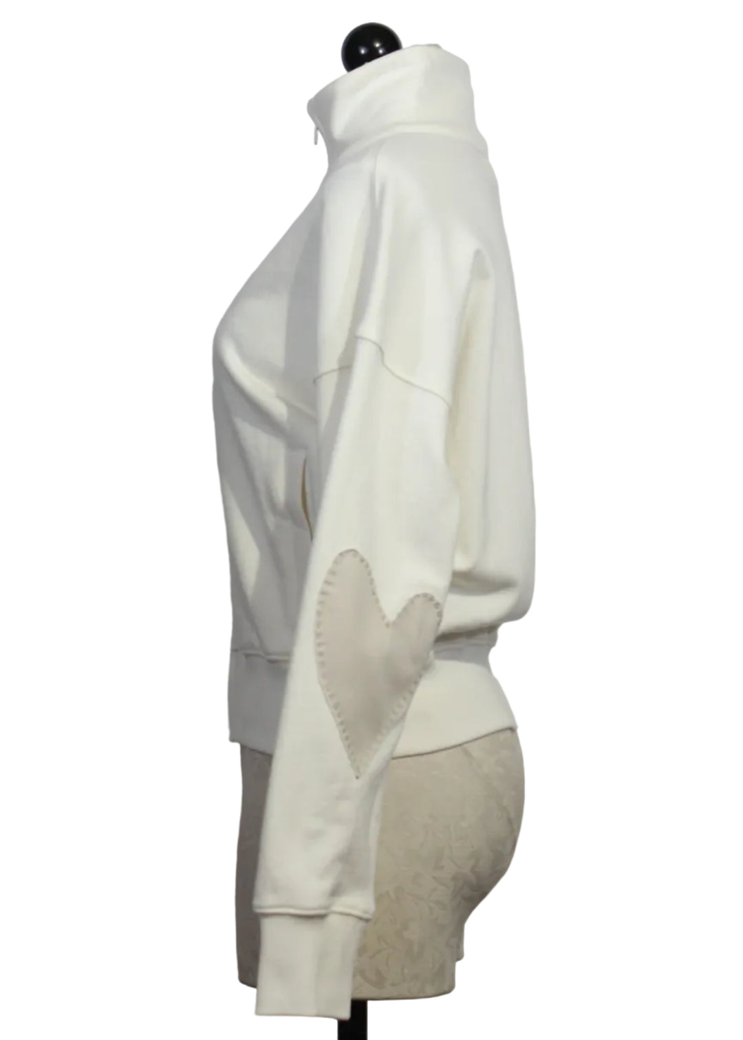 side view of Cream Colored Zip Up Mock Neck Sweatshirt by Kerri Rosenthal with taupe-colored heart patches on the sleeves