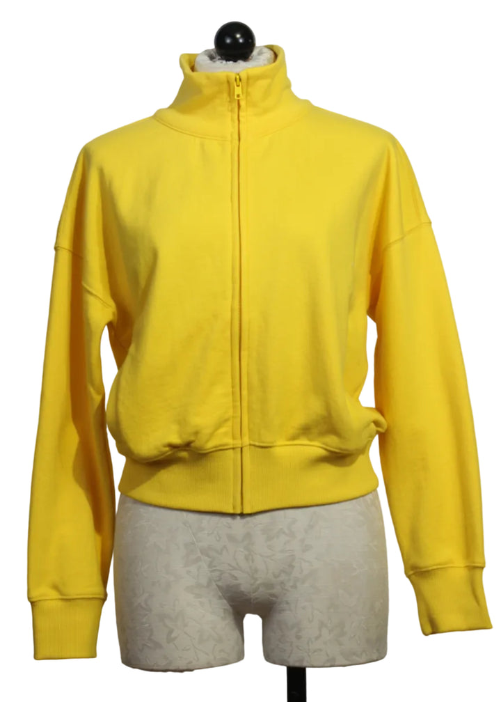 Golden Yellow Colored Zip Up Mock Neck Sweatshirt by Kerri Rosenthal with cream-colored heart patches on the sleeves.
