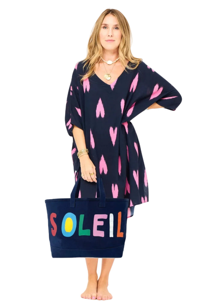 model holding the Soleil Beach Tote by Kerri Rosenthal in navy indigo blue 