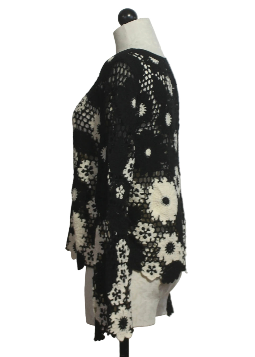 side view of  Black and White Floral Crochet Pullover by Adore 