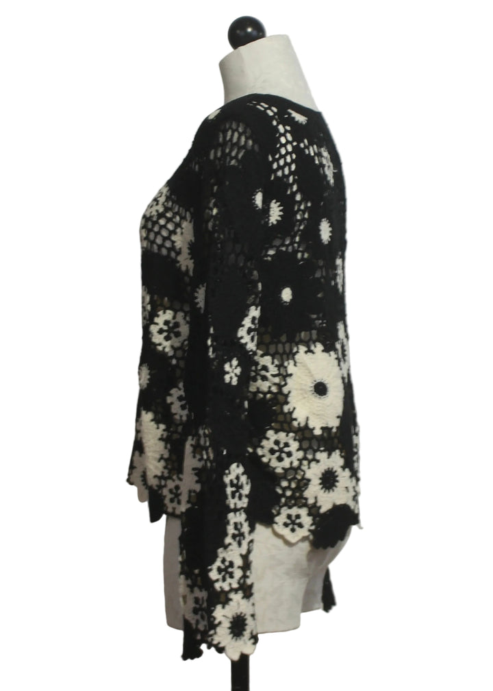 side view of  Black and White Floral Crochet Pullover by Adore 
