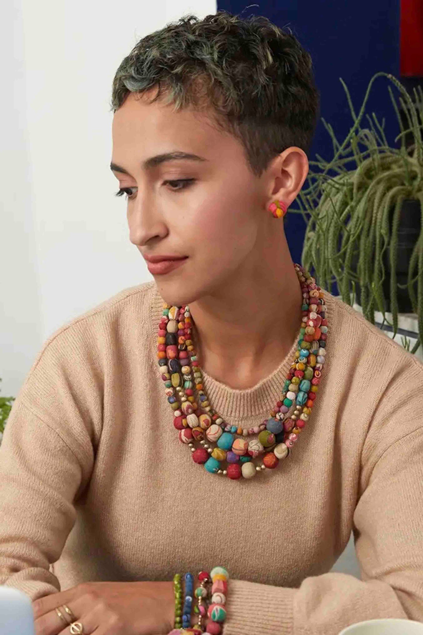 model wearing the multicolored 4-stranded Kantha Aura Necklace by World Finds with matching World Finds bracelets