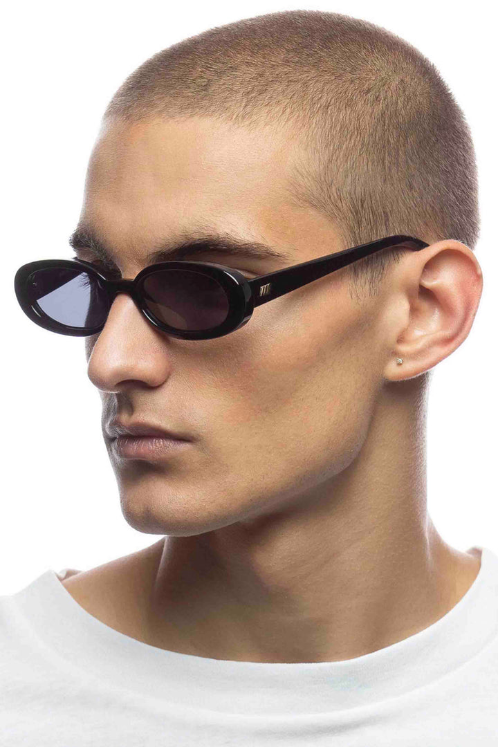 side view of male model wearing Black Outta Love Sunglasses by Le Specs