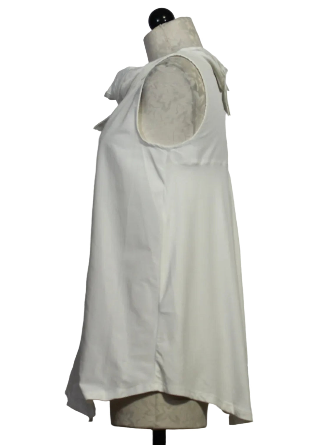 side view of Branco colored Amber Top by Kozan is a sleeveless tunic with a pleated neck