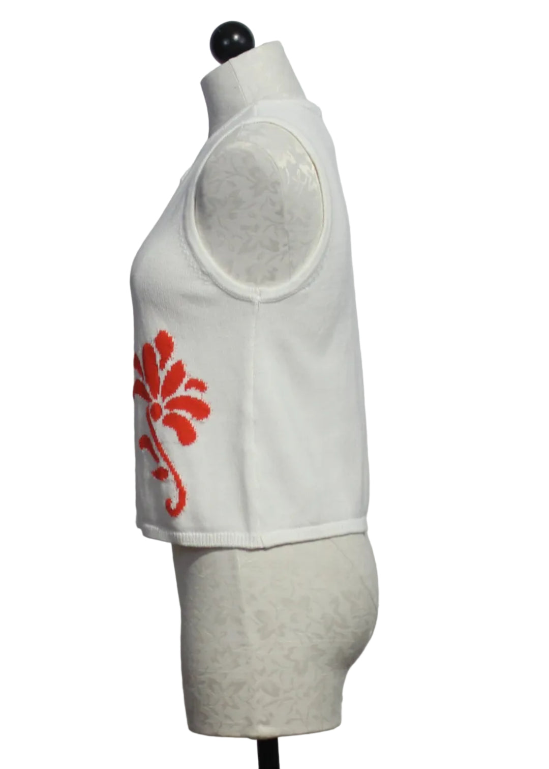side view of Off-White sleeveless button-down Freesia Top by Melissa Nepton with with an orange jacquard design on each front side 