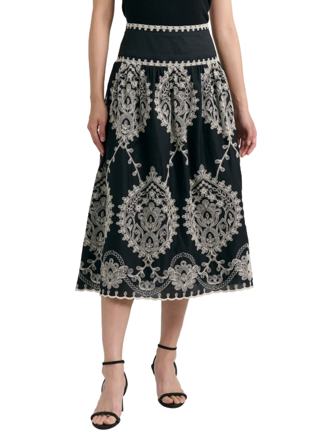 modeling wearing the Noir colored Embroidered Georgina Midi Skirt by Cartolina