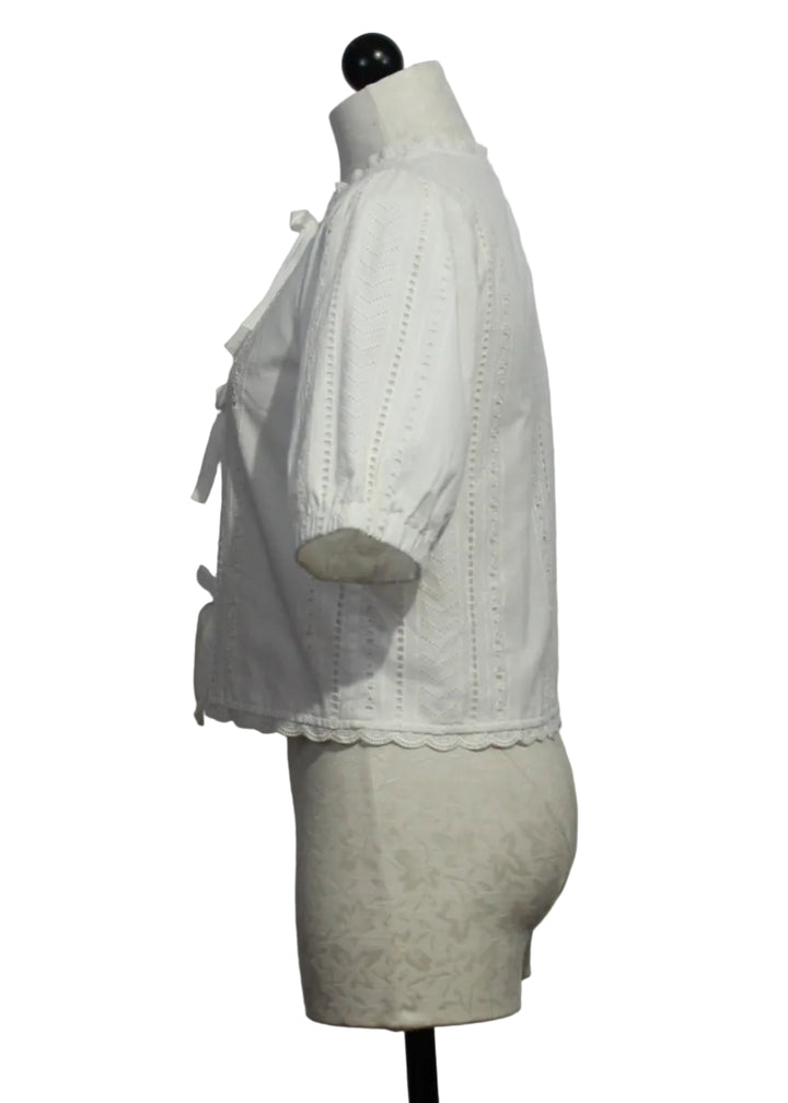side view of Off-White Puff Sleeve Giana Tie Front Eyelet Top by Melissa Nepton 