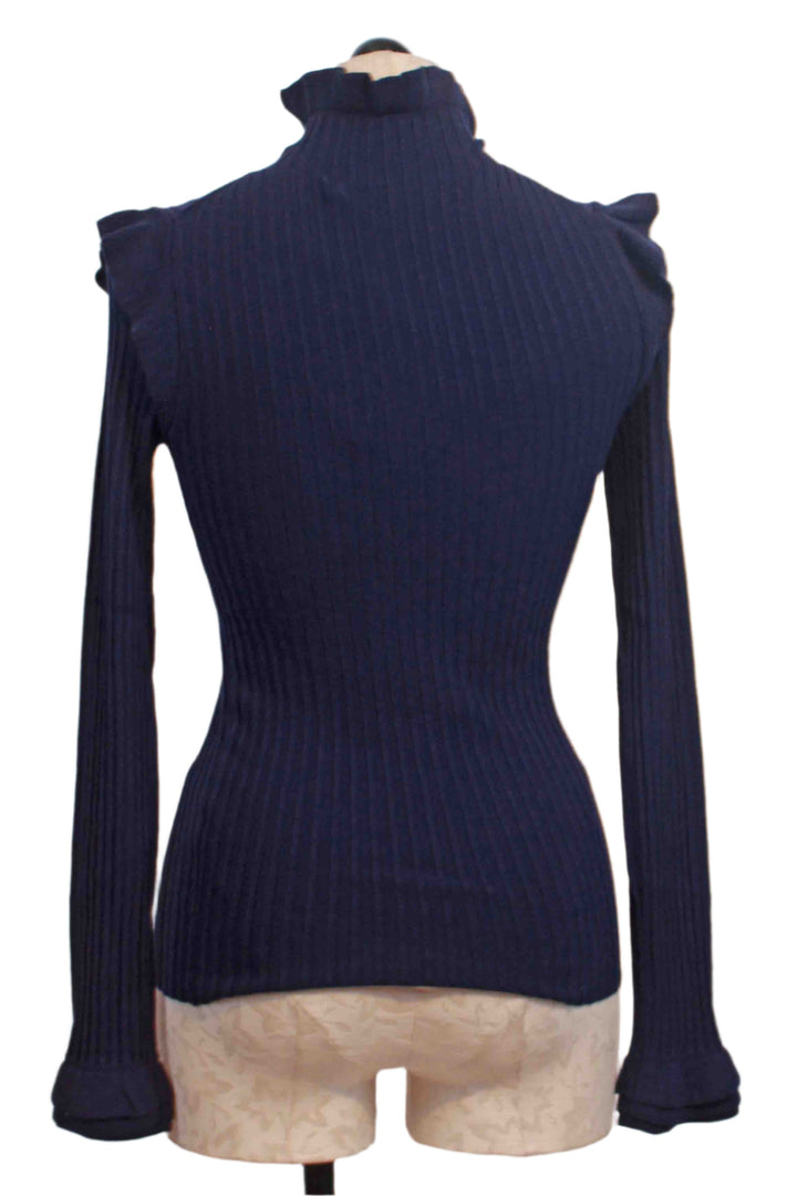 back view of Dusk ribbed Turtleneck by Marie Oliver with tiny ruffle shoulder neckline and bottom of sleeve