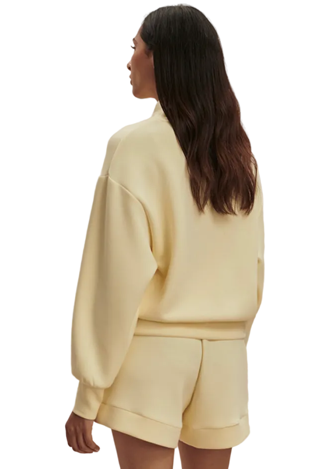 back view of Model wearing the The Davidson Sweat in Anise Flower by Varley paired with The Atrium High Rise Short 4.5 In Anise Flower Color by Varley 