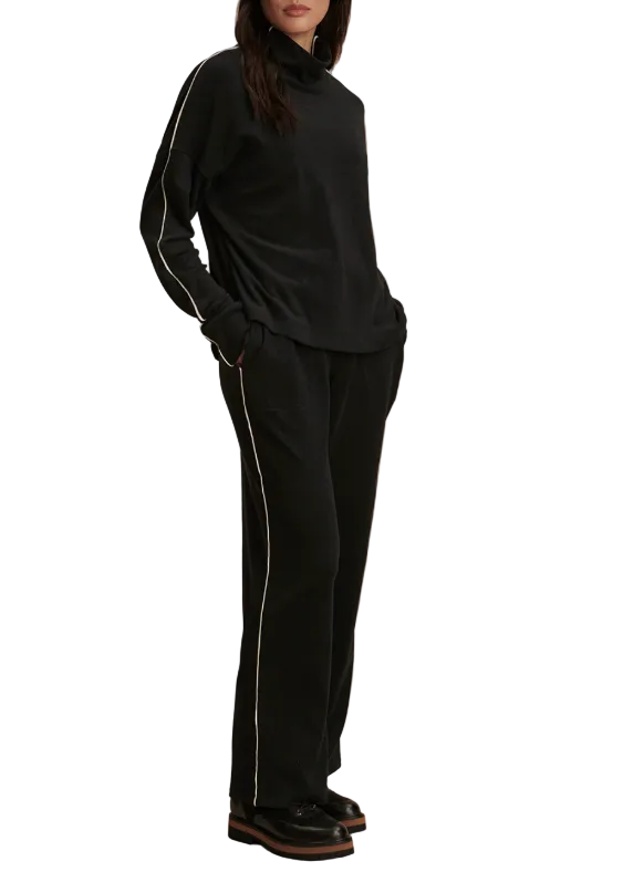 side view of The Brushed Rib Straight Leg Pant 28 by Varley in Black/Snow White paired with the matching Rona High Neck Midlayer by Varley