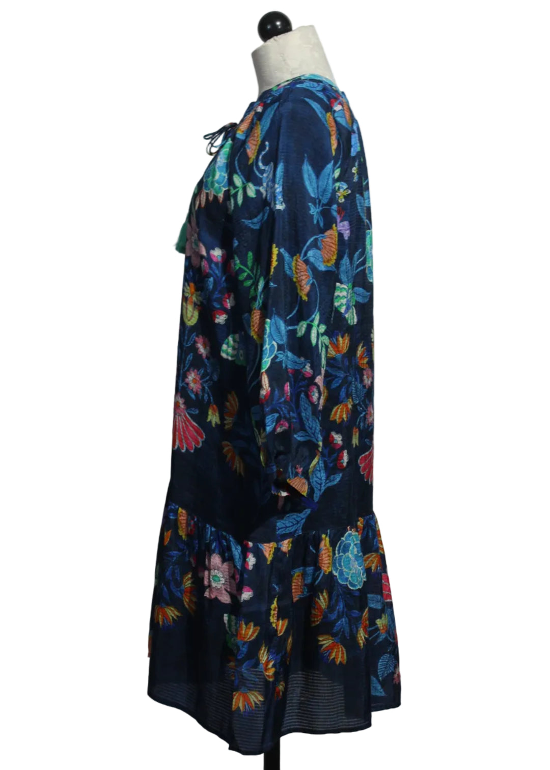 side view of The Tassel Dress by Johnny Was in the bright blue floral Elizabeth print with turquoise blue tassels